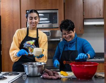 OSU Extension nutrition educators Iris Carrera and Itzel Arizmendi prepare recipes in the Linn County office's demonstration kitchen with winter vegetables procured from local farmers.
