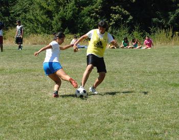 two people competing for a soccer ball