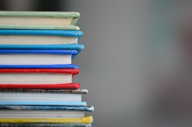 Different colored books stacked