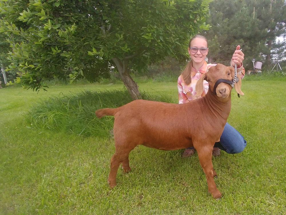 McKenzie Shelden poses with her Boer goat. 
