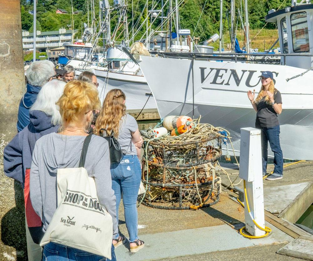 Angee Doerr, a Sea Grant Extension marine fisheries educator, explains crabbing at the Shop at the Dock tour at the Port