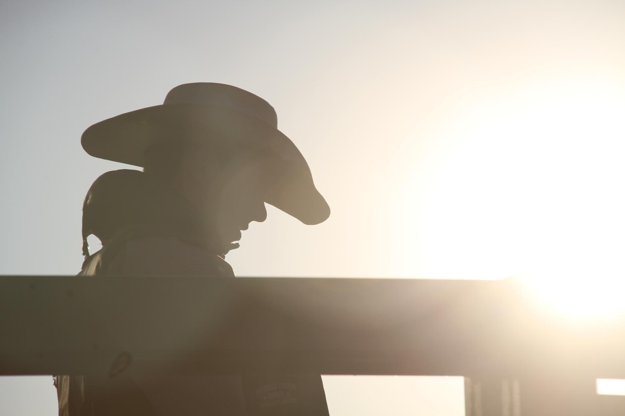 Silhouette of a person wearing a cowboy hat