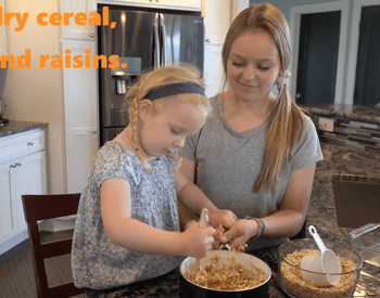 Jamie Cox and her daughter make peanut butter cereal bars