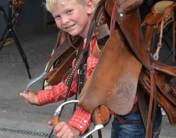 blonde boy with saddle