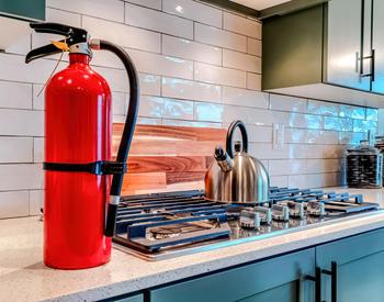 A Fire extinguisher on a kitchen counter.