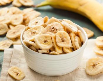 A bowl of dehydrated banana slices, also known as "banana chips."