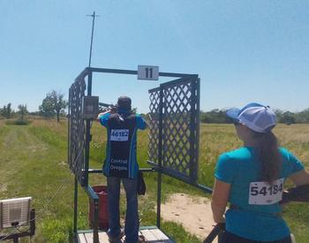 A 4-H competitor uses a shotgun in the clay target competition.