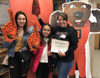 Newly admitted OSU students with beaver mascot and number one sports memorbilia