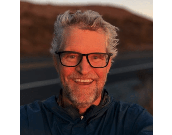 smiling person outside wearing glasses
